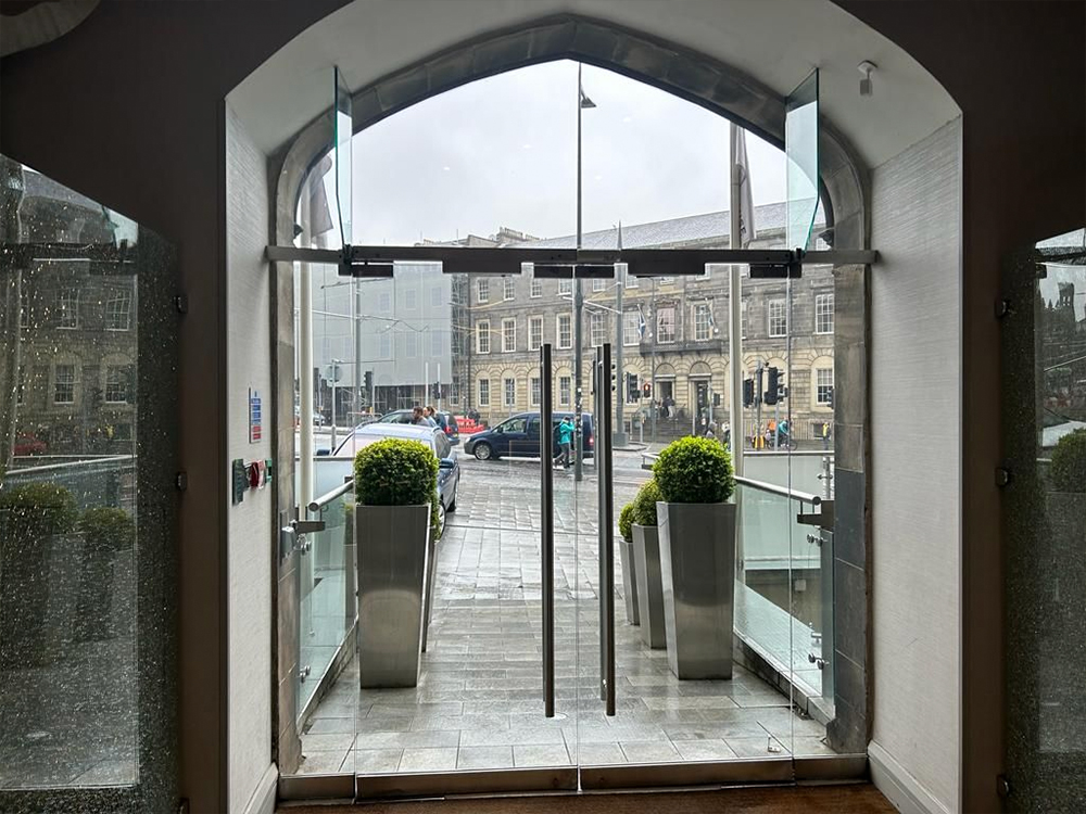 Technician repairing internal glass door in London